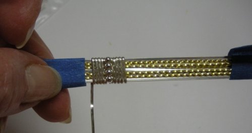 Judy Larson's Two-tone Beaded Bangle - , Classic Wire Jewelry, Wire Wrapping, Wrapping, Wire Wrapping Jewelry, Continue until the final wrap on the first side of the beads covers the bead wire on the front of the wire bundle-first photo. 